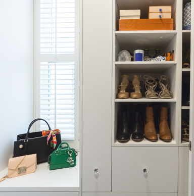 Fitted shelving used as shoe rack and bag storage